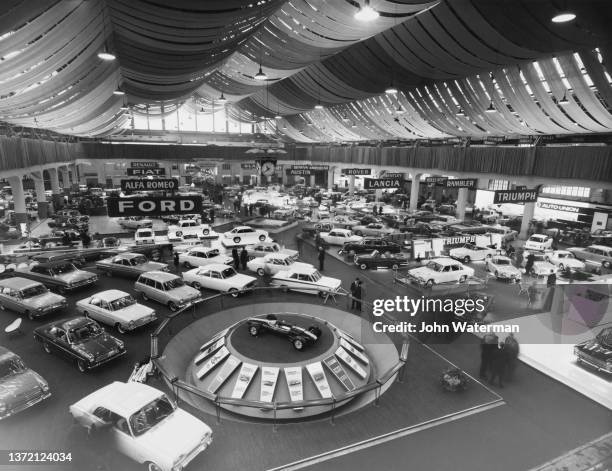 General view of motor car manufacturer exhibitors Ford, Alfa Romeo, Lancia, Triumph, Austin, FIAT, Renault and Rover at the 34th Geneva International...