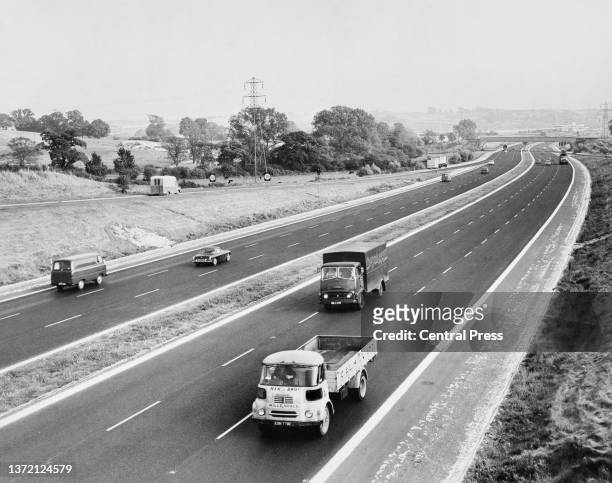General elevated view of motor cars and commercial lorries driving on the M1 six lane Motorway linking London to the Midlands circa June 1966 in...