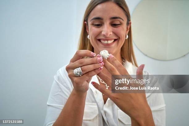 jewelry: woman shopper trying on pretty ring - ring schmuck stock-fotos und bilder