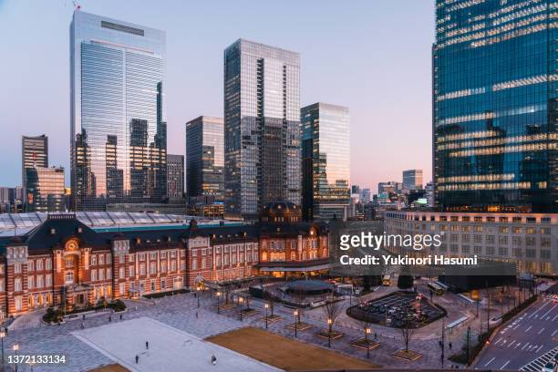 tokyo station and the nearby skyline at twilight in winter - tokyo station stock pictures, royalty-free photos & images