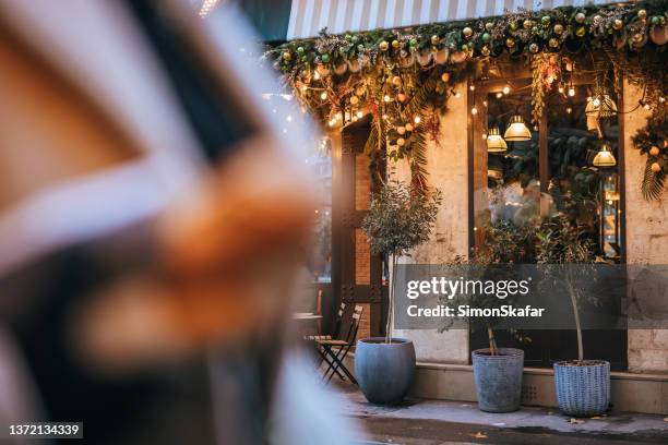 close-up fancy of italian restaurant with christmas decoration and lights on the top, paris - paris christmas stock pictures, royalty-free photos & images