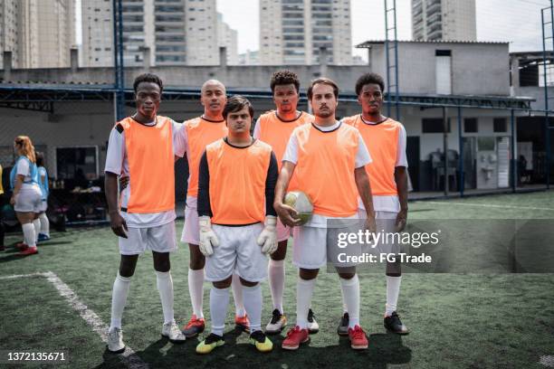 portrait of team players on the soccer field - including a person with special needs - local soccer field stock pictures, royalty-free photos & images