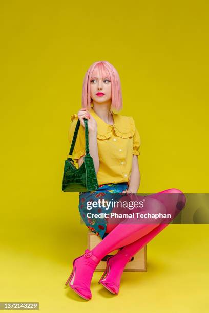 beautiful woman with pink hair - fashion handbag stock pictures, royalty-free photos & images