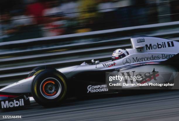 David Coulthard of Great Britain lights up the brake discs as he drives the West McLaren Mercedes McLaren MP4/12 Mercedes V10 during the Formula One...