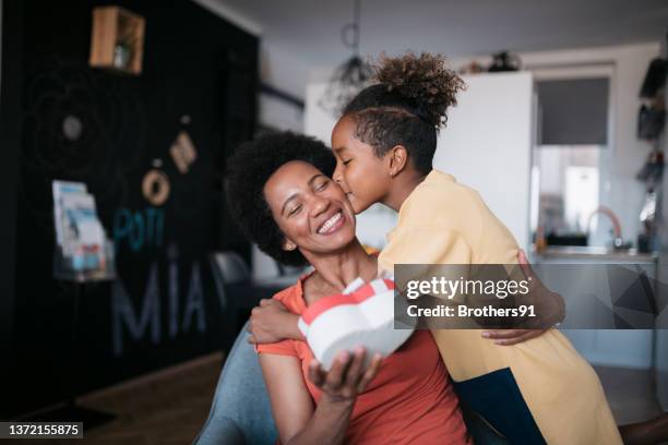 african american mother and daughter celebrating mother's day at home - mother day stockfoto's en -beelden