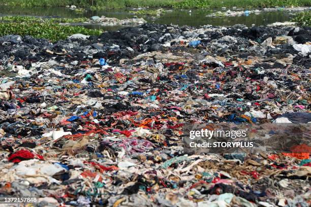 garment factory waste dump contributes to environmental issues in bangladesh - waste stock pictures, royalty-free photos & images