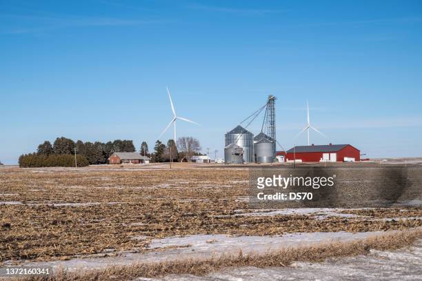 iowa farm with wind turbines in the background - iowa house stock pictures, royalty-free photos & images