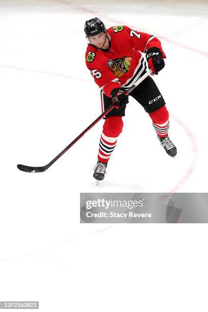 Alec Regula of the Chicago Blackhawks controls the puck during a game against the Dallas Stars at United Center on February 18, 2022 in Chicago,...