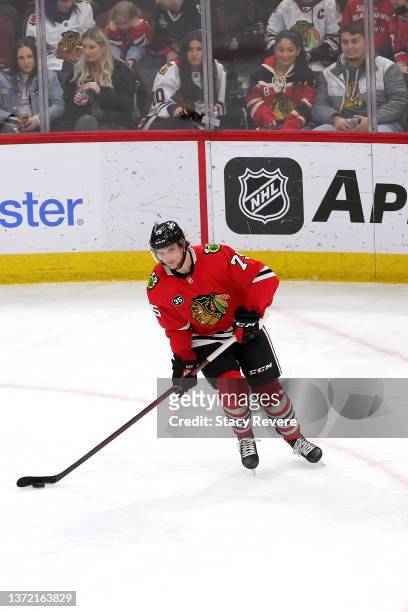 Alec Regula of the Chicago Blackhawks controls the puck during a game against the Dallas Stars at United Center on February 18, 2022 in Chicago,...