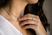 womanwith ring holding necklace