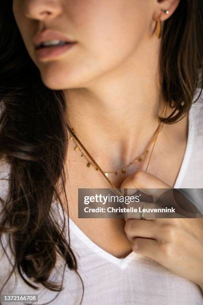 woman wearing ring and holding necklace - necklace stock pictures, royalty-free photos & images