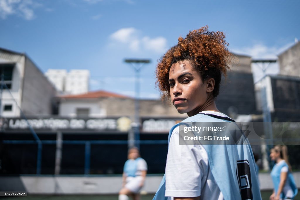 Portrait of a young female soccer player in a sports court