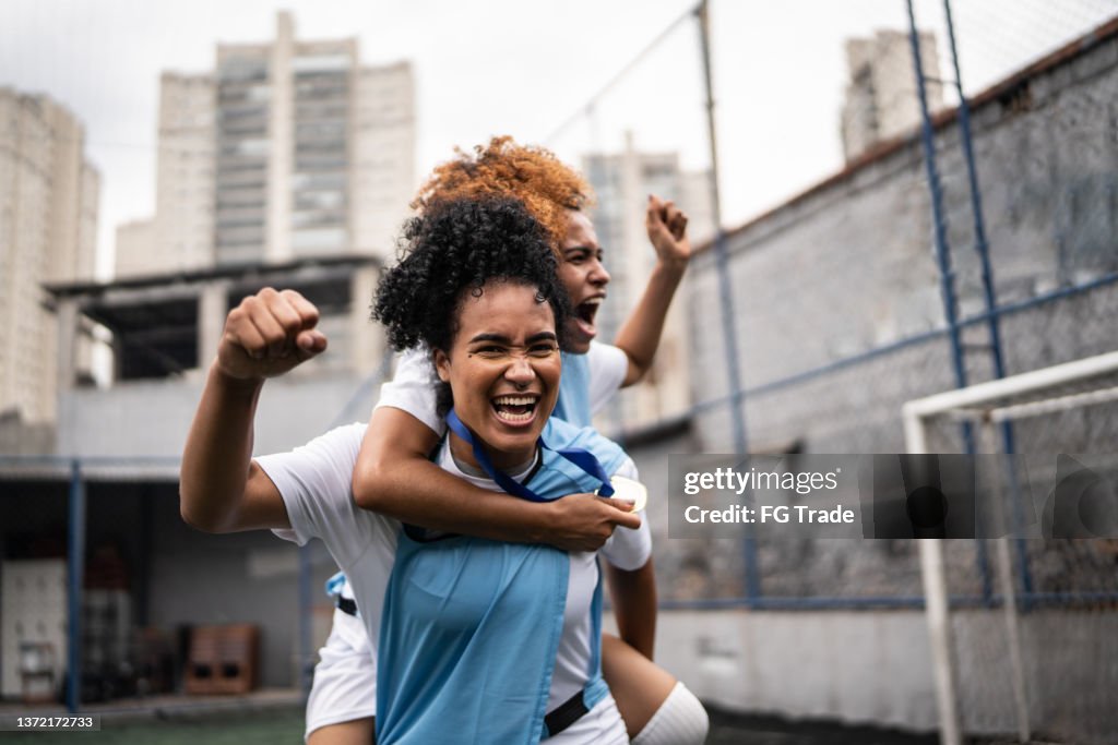 Female soccer players celebrating a goal