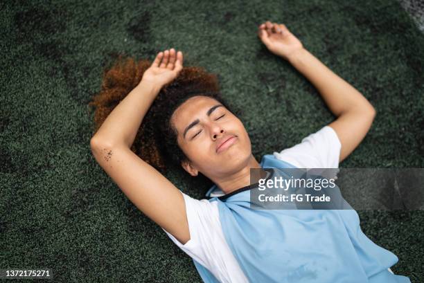 exhausted female soccer player - lying down stock pictures, royalty-free photos & images
