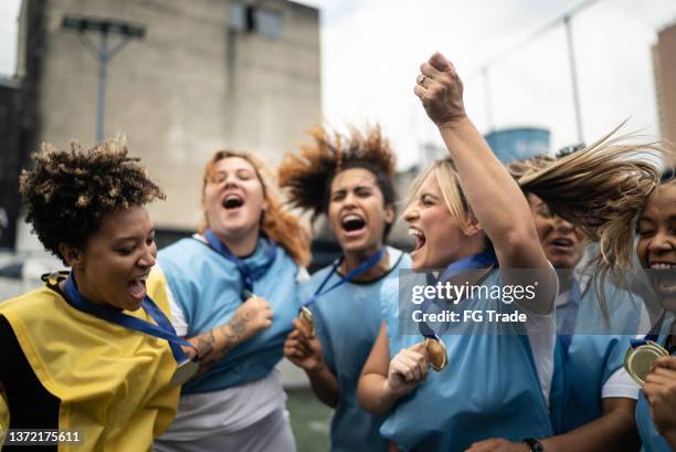 female soccer players celebrating winning a medal - medalist stock pictures, royalty-free photos & images
