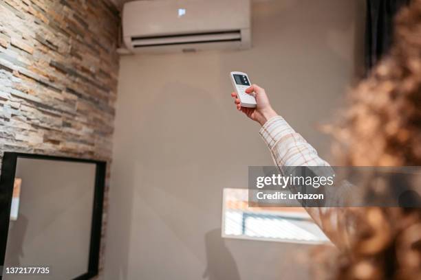 turning on the air conditioner - airco stockfoto's en -beelden