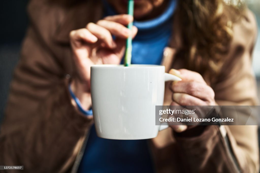 Unrecognizable woman with matcha tea cup