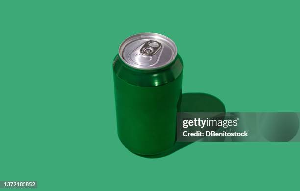 green beer or soda cans with hard shadow on green background. soda, beer, drink, alcohol, bar, brewery, industry and factory concept. - soft drink stock-fotos und bilder