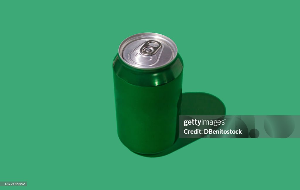 Green beer or soda cans with hard shadow on green background. Soda, beer, drink, alcohol, bar, brewery, industry and factory concept.