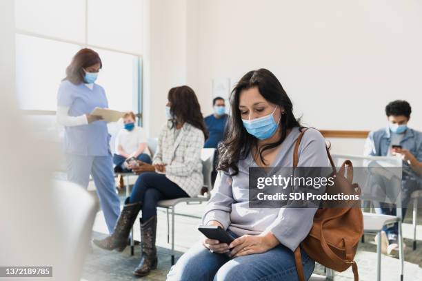 adult woman waits in the waiting room - patient waiting stock pictures, royalty-free photos & images