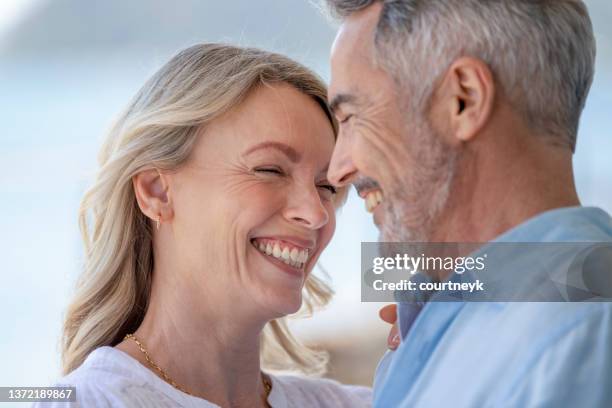 mature couple dancing. they are smiling, laughing  and having fun - photograph 51 play stockfoto's en -beelden