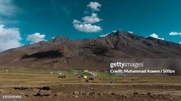 landscape of meadow with mountains,scenic view of landscape and mountains against sky,shandur pass,pakistan - shandour pass stock pictures, royalty-free photos & images