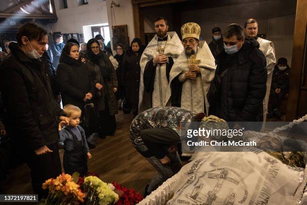 Woman pays her respects to Captain Anton Olegovich Sidorov during his funeral on February 22, 2022 in Kyiv, Ukraine. On February 22, 2022 in Kyiv,...