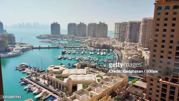 high angle view of buildings by sea against sky,doha,qatar - qatar stock pictures, royalty-free photos & images