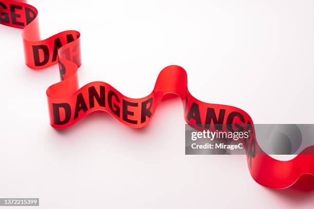 s-shaped curved danger cordon tape - banchina stock pictures, royalty-free photos & images