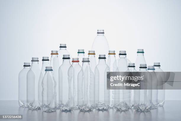 empty plastic bottles arranged on white background - plastic bottle stock pictures, royalty-free photos & images