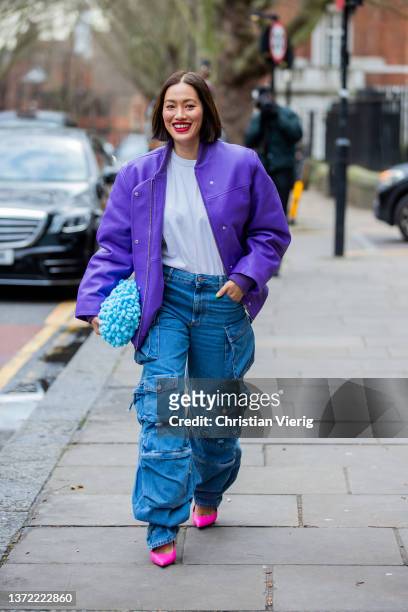 Tiffany Hsu seen wearing purple jacket, denim jeans with pockets, blue bag, pink heels outside Erdem during London Fashion Week February 2022 on...