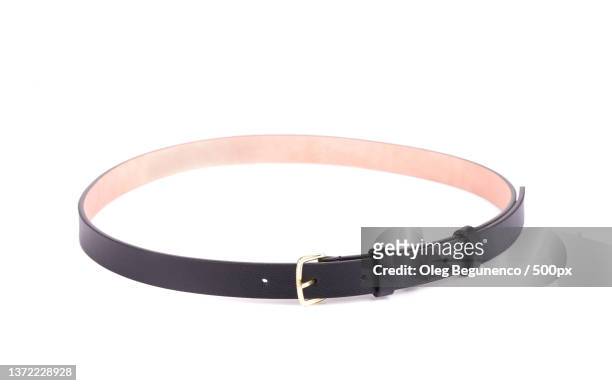 rolled up black female belt,high angle view of belt against white background,moldova - black belt fashion item photos et images de collection