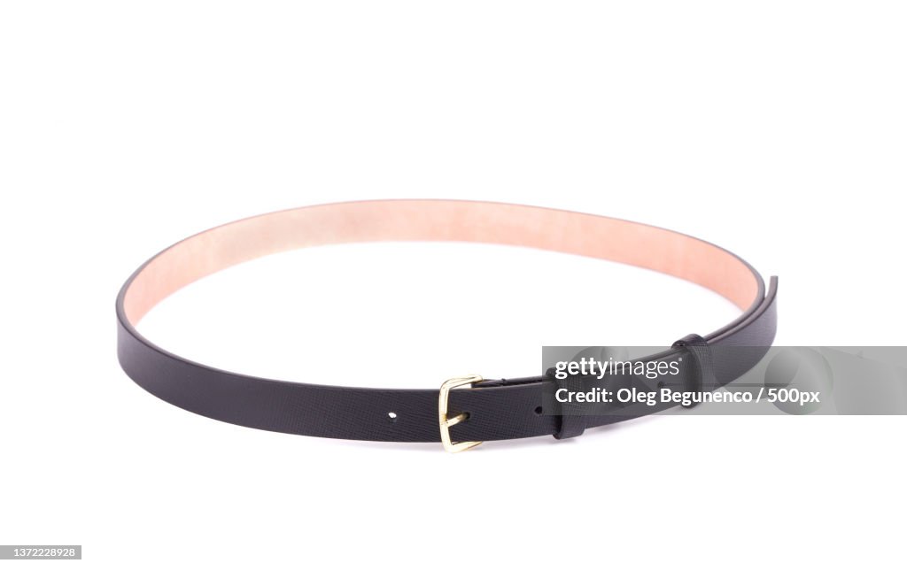 Rolled up black female belt,High angle view of belt against white background,Moldova