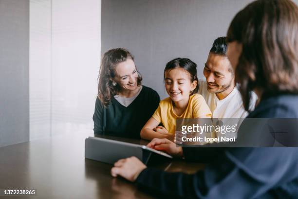 family consulting with real estate agent - children interacting with tablet technology stock pictures, royalty-free photos & images