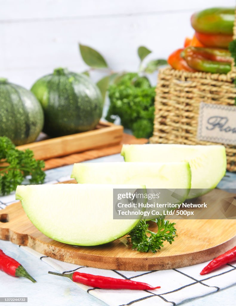 There are cut pumpkins on the board