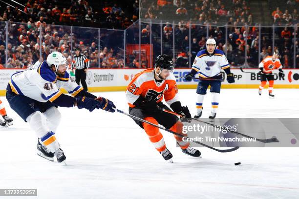 Robert Bortuzzo of the St. Louis Blues challenges Scott Laughton of the Philadelphia Flyers for the puck during the second period at Wells Fargo...