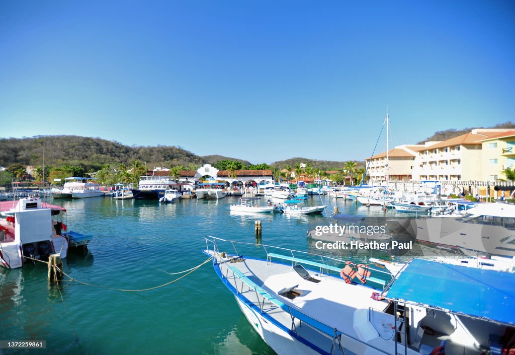 Tour boats and yachts docked at the marina in Huatulco, Mexico