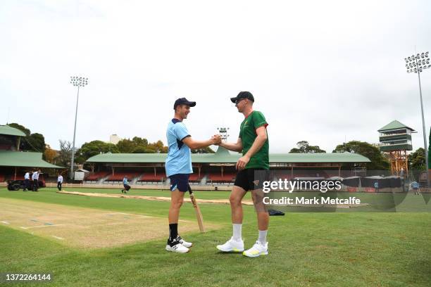 Hayden Kerr of the Blues and Tom Rogers of the Tigers greet eachother in the middle before the Marsh One Day Cup match between New South Wales and...