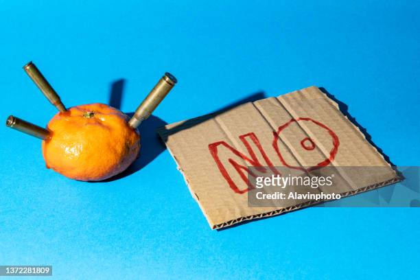 tangerine that has been shot with a no sign - leuchtgeschoss stock-fotos und bilder