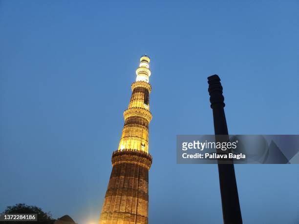View of the Iron Pillar of Delhi in the Qutab Minar complex at night on February 20, 2022 in New Delhi, India.