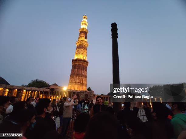 View of the Iron Pillar of Delhi in the Qutab Minar complex at night on February 20, 2022 in New Delhi, India.