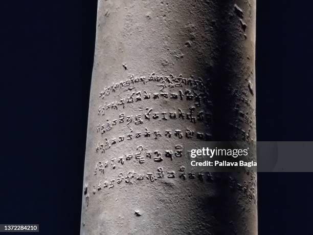 Calligraphy written in the ancient Indian language Pali on the Iron Pillar at night on February 20, 2022 in New Delhi, India.