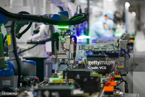 Robotic arm is seen on the assembly line of computer at a computer manufacturing enterprise set up by Tsinghua Tongfang Co., Ltd on February 22, 2022...