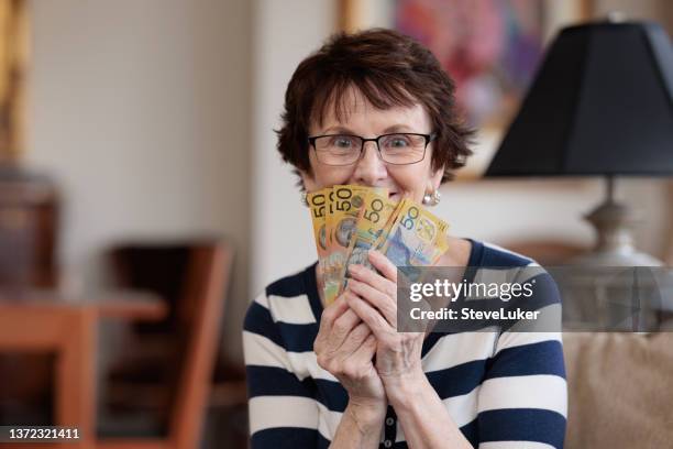 happy woman with money - australian dollar stockfoto's en -beelden