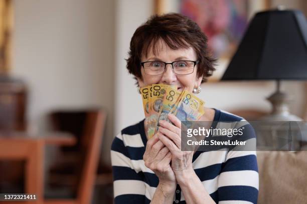 happy woman with money - australian money stock pictures, royalty-free photos & images
