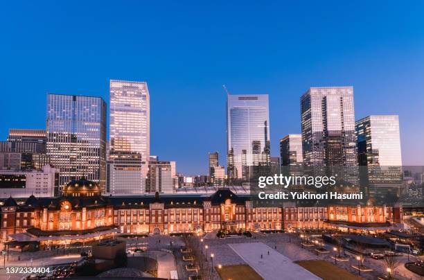 tokyo station and the nearby skyline at twilight in winter - tokyo station stock pictures, royalty-free photos & images