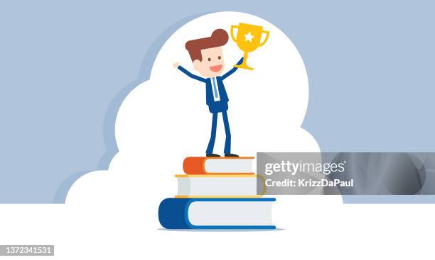 businessman holding trophy on stack of books - winning trophy hands stock illustrations