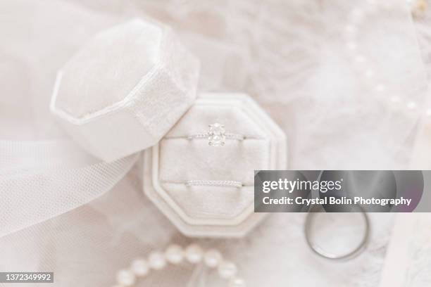 white gold diamond wedding rings in a velvet ring box in bright natural light - white gold stock pictures, royalty-free photos & images