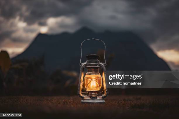 classic lanterns hanging on poles - windlicht stock-fotos und bilder