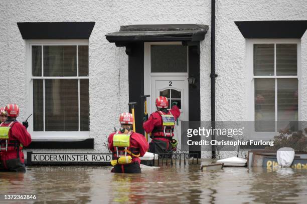 Personnel from the Severn Area Rescue Association wade through flood water in Bewdley to check on the welfare of residents after the River Severn...